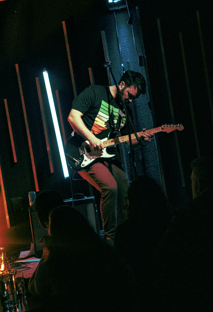 Guitarist under neon lights